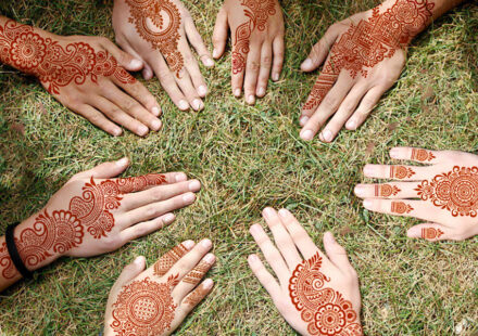 Reusable henna tattoo stencils kit featuring 9 Mehendi design sheets for hands, forearms, glitter tattoos, and temporary body art.
