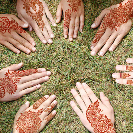 Reusable henna tattoo stencils kit featuring 9 Mehendi design sheets for hands, forearms, glitter tattoos, and temporary body art.