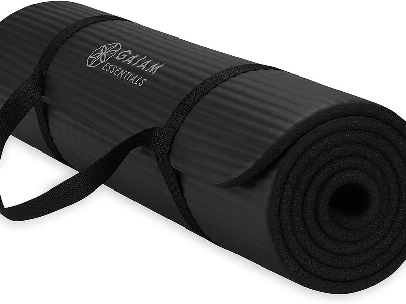 Gaiam thick yoga mat for exercise, yoga, stretching, and fitness with an easy-cinch carrying strap.